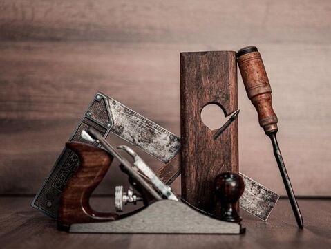 Close up of carpentry tools against wood backdrop